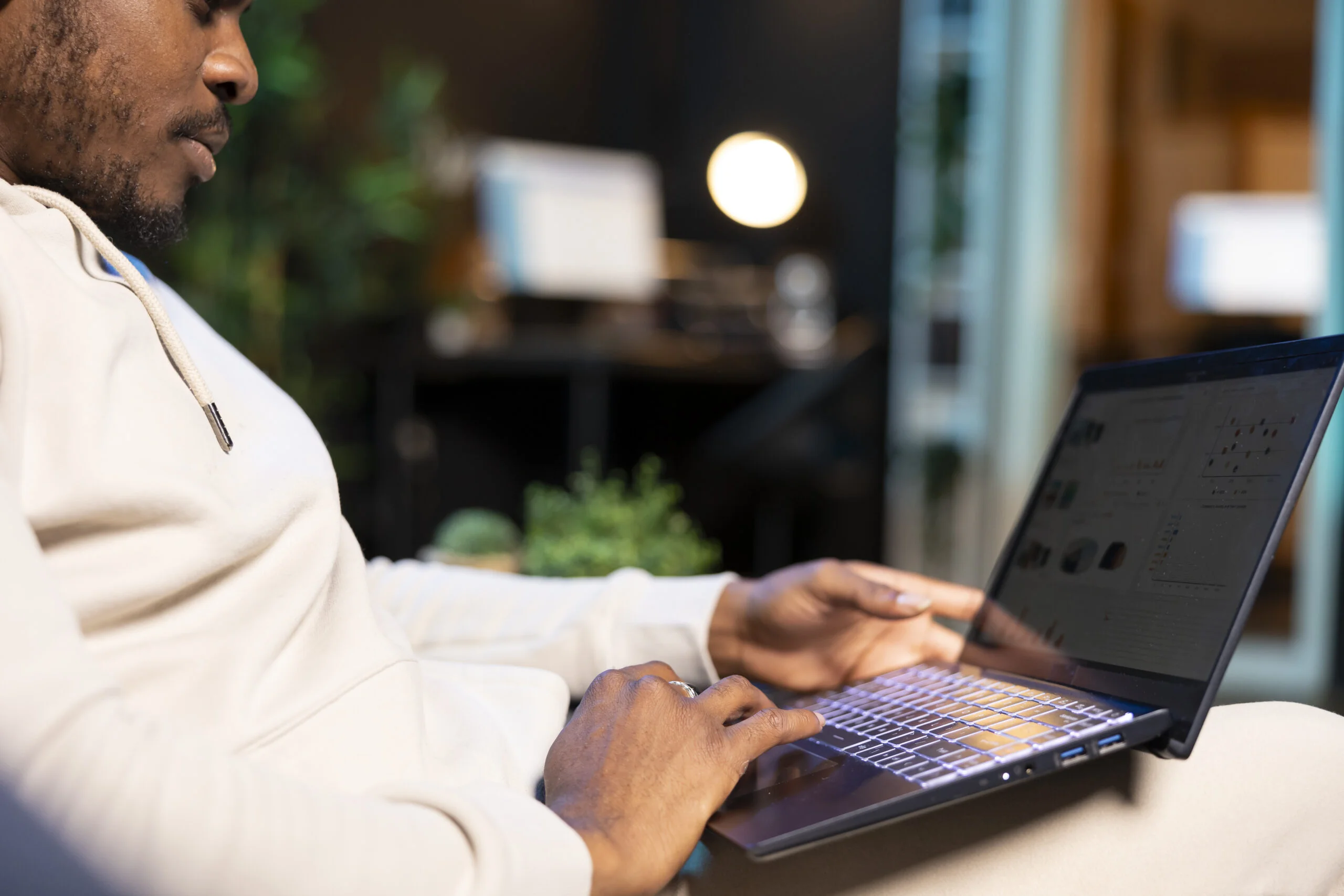 Man in apartment analyzing business charts, close up shot