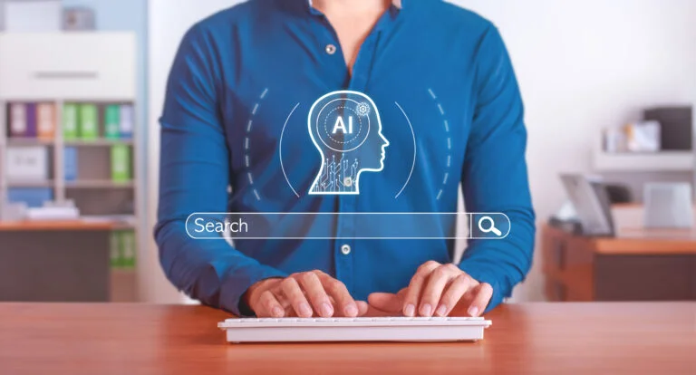 Pessoa digitando em um teclado, com ícones de inteligência artificial e uma barra de pesquisa em primeiro plano